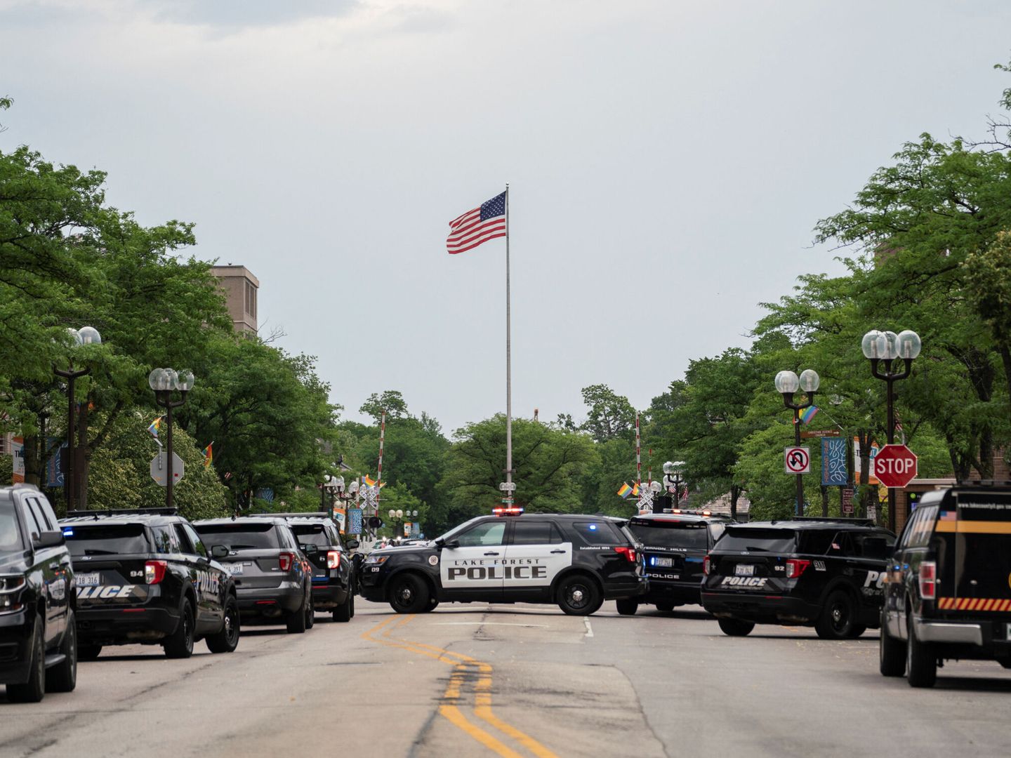 Coches de las fuerzas de seguridad vigilan la escena de un tiroteo masivo en Highland Park, Illinois, Estados Unidos, el 4 de julio de 2022. (Reuters/Max Herman)
