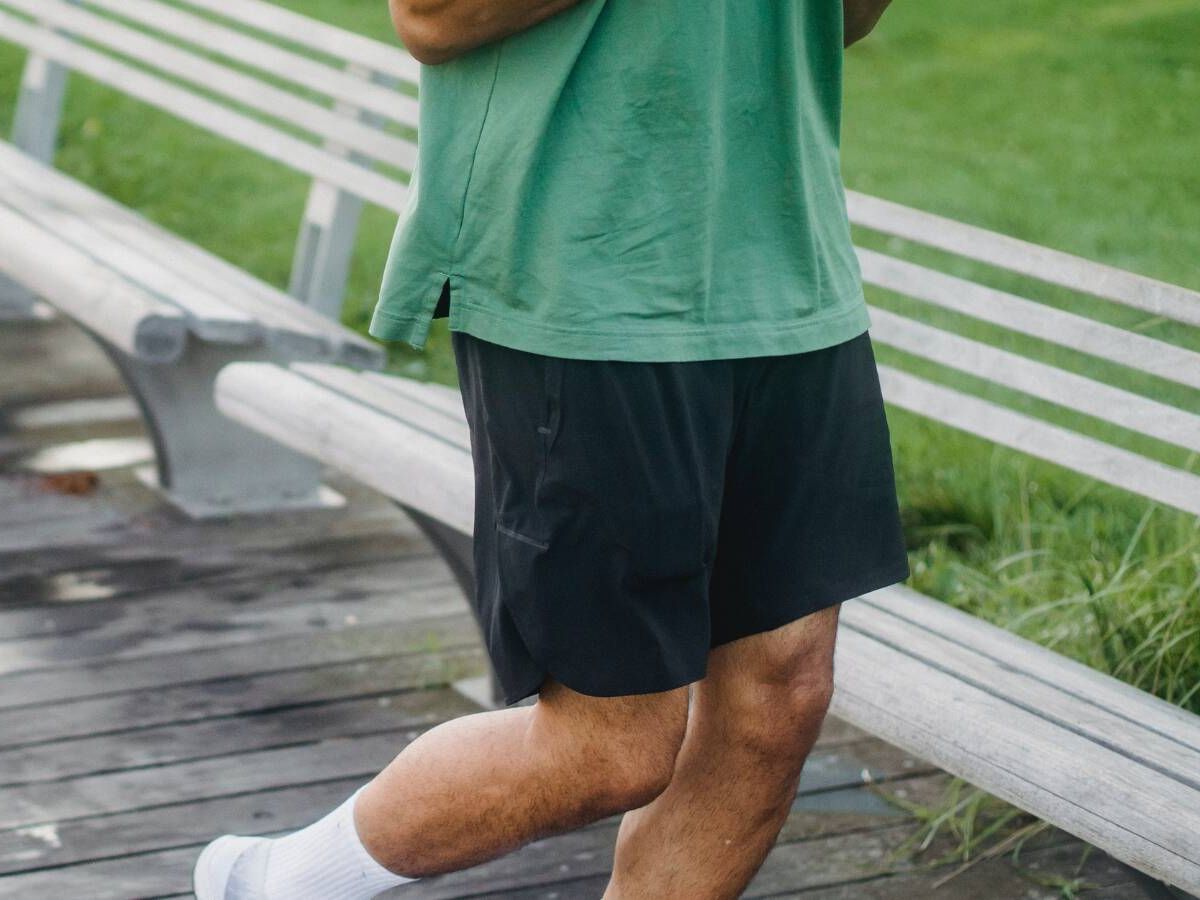 Hombre en ropa deportiva se prepara para hacer ejercicio al aire libre
