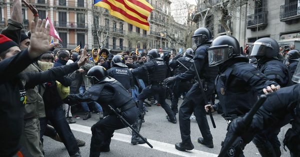 Foto: Los Mossos d'Esquadra impiden el paso de manifestantes en las inmediaciones de la Delegación del Gobierno en Cataluña este domingo. (EFE)