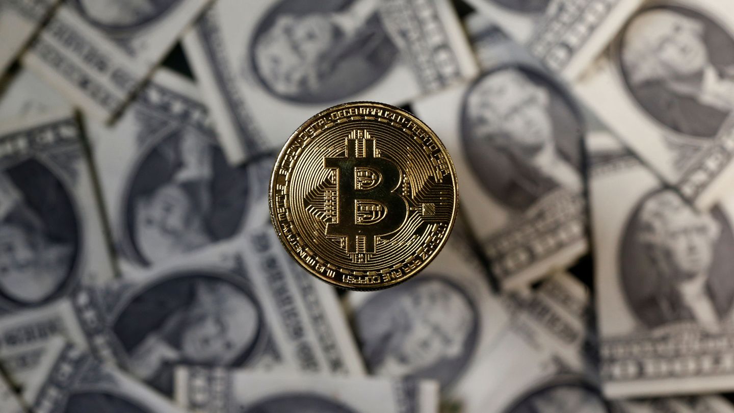 A bitcoin (virtual currency) coin placed on Dollar banknotes is seen in this illustration picture, November 6, 2017. REUTERS Dado Ruvic Illustration