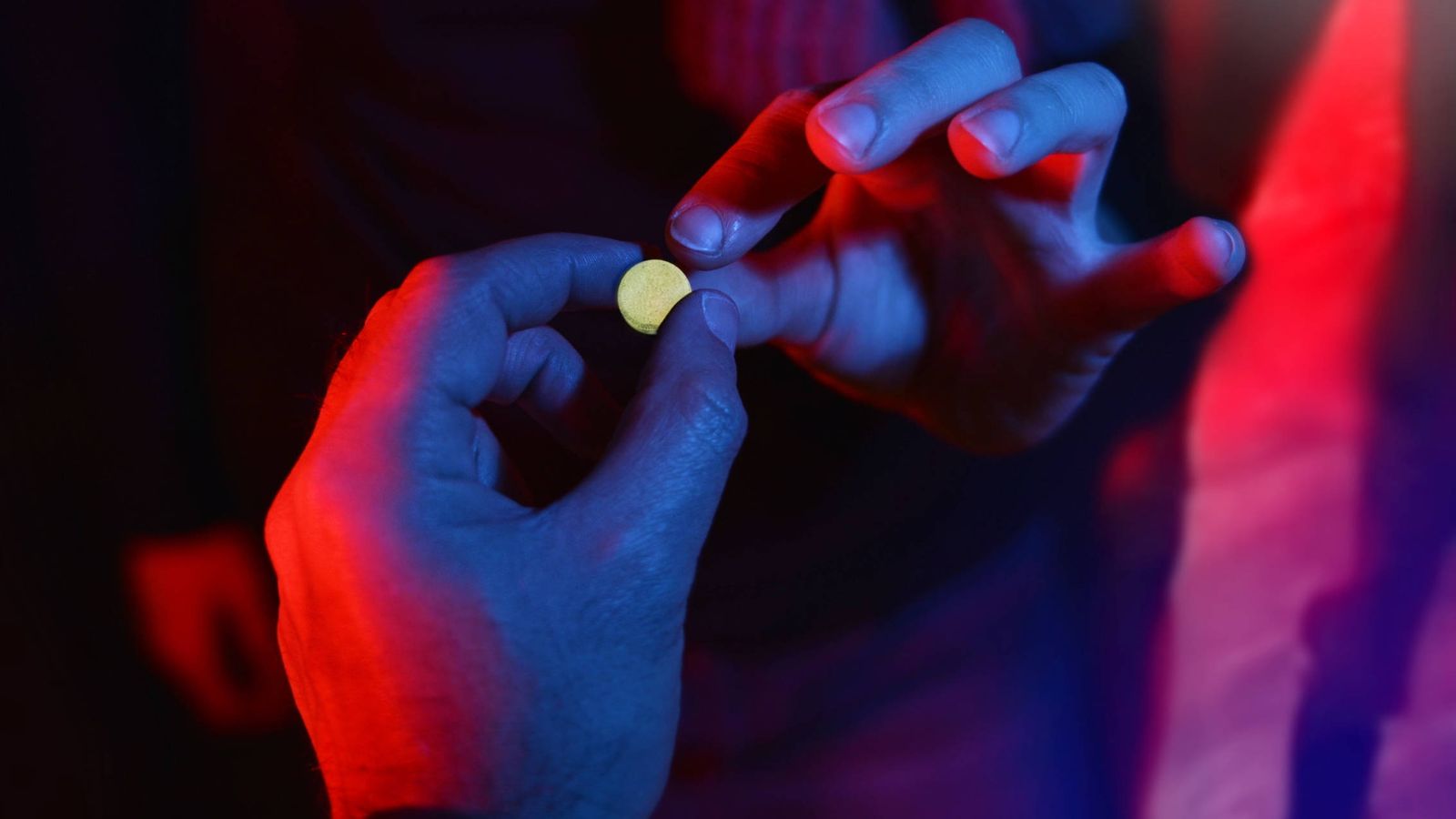 Foto: Una pastilla (que no se sabe lo que contiene), cambiando de manos. (iStock)