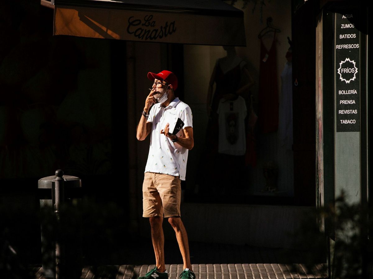 Foto: Un hombre fuma en plena vía pública en el centro de Málaga. (EFE)