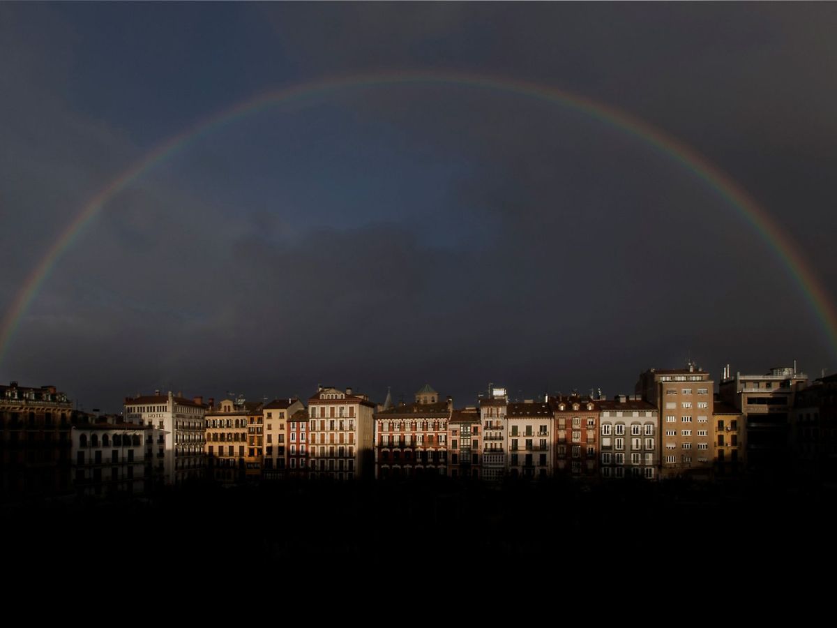 Foto: Un arcoíris sobre unas viviendas en Pamplona. (EFE)