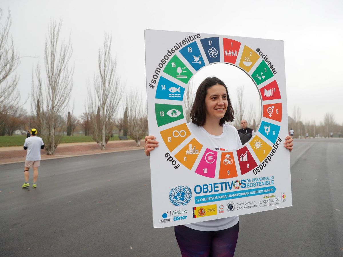 Foto: Una joven sostiene el logo de los Objetivos de Desarrollo Sostenible. (EFE)