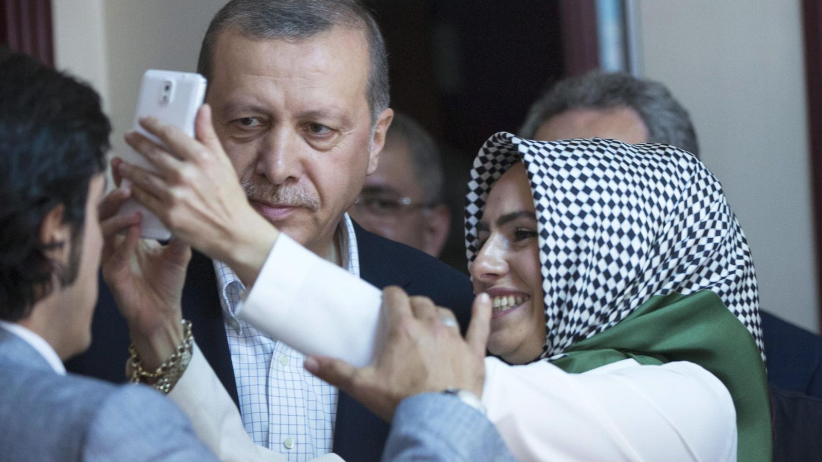 Foto: Una mujer se hace una foto con Erdogan durante la pasada jornada electoral (EFE)