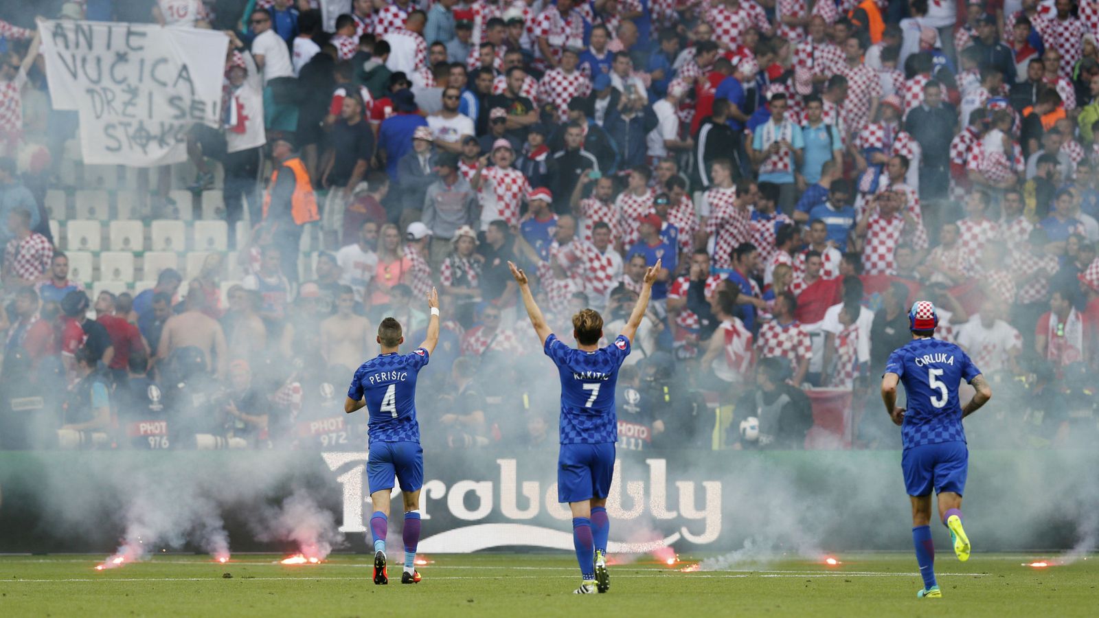 Foto: Croatia players gesture towards fans as flares are on the pitch