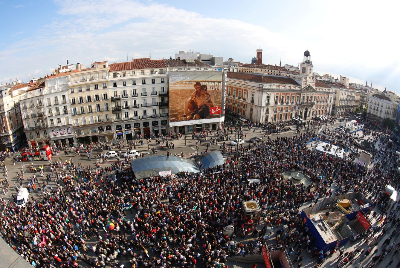 Vista de una manifestación en la Puerta del Sol por el aniversario del 15-M con uno de los edificios cubierto con un gran anuncio. (Reuters)