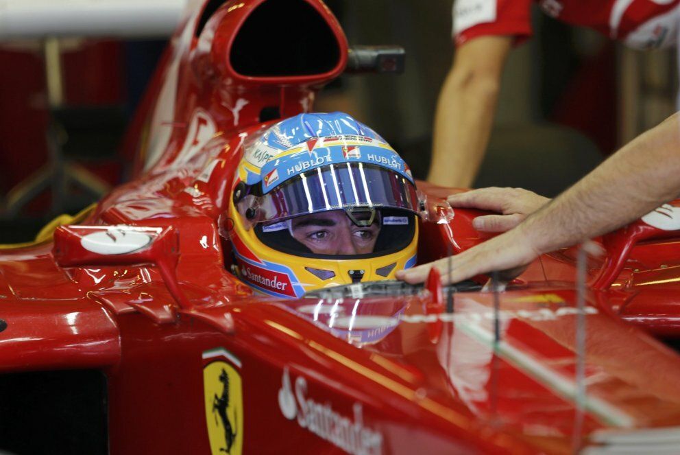 Ferrari formula one driver alonso of spain sits in his car during the third practice session of the abu dhabi f1 grand prix at the yas marina circuit on yas island
