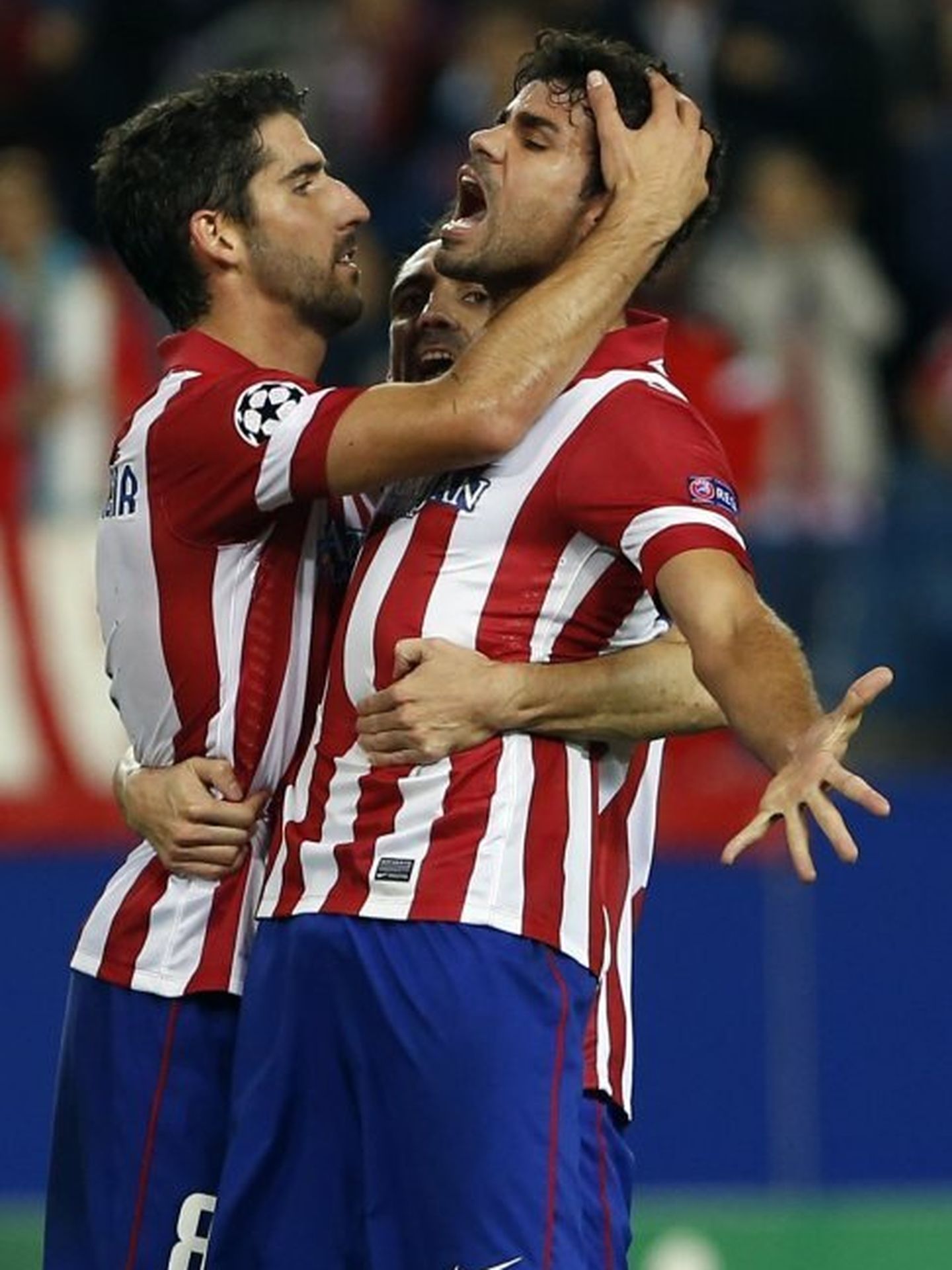 Atletico madrid's costa celebrates scoring against austria vienna with teammates garcia and 'juanfran' during their champions league group g soccer match at vicente calderon stadium in madrid