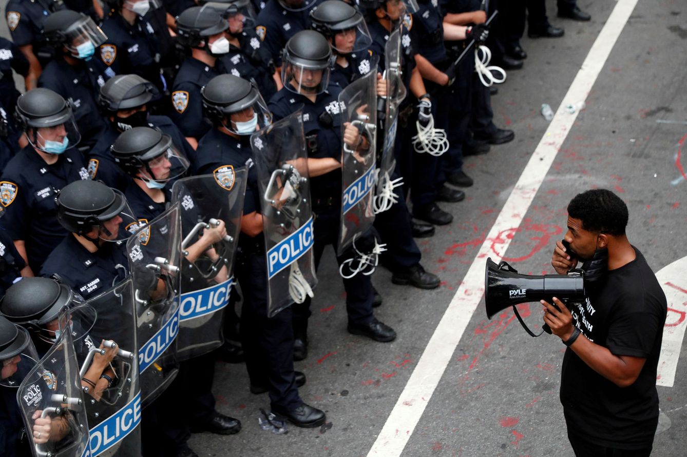 Un manifestante frente a agentes antidisturbios de la policía de Nueva York. (Reuters)