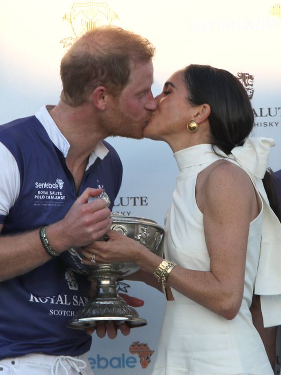 Meghan Markle, besando al príncipe Harry cuando le entrega el trofeo. (Gtres)