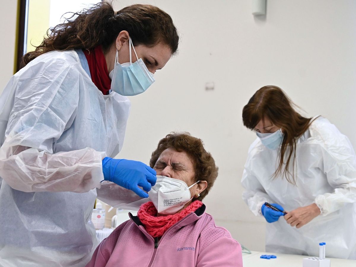 Foto: Un sanitario realiza un test de antígenos en Alcalá de Henares. (EFE) 