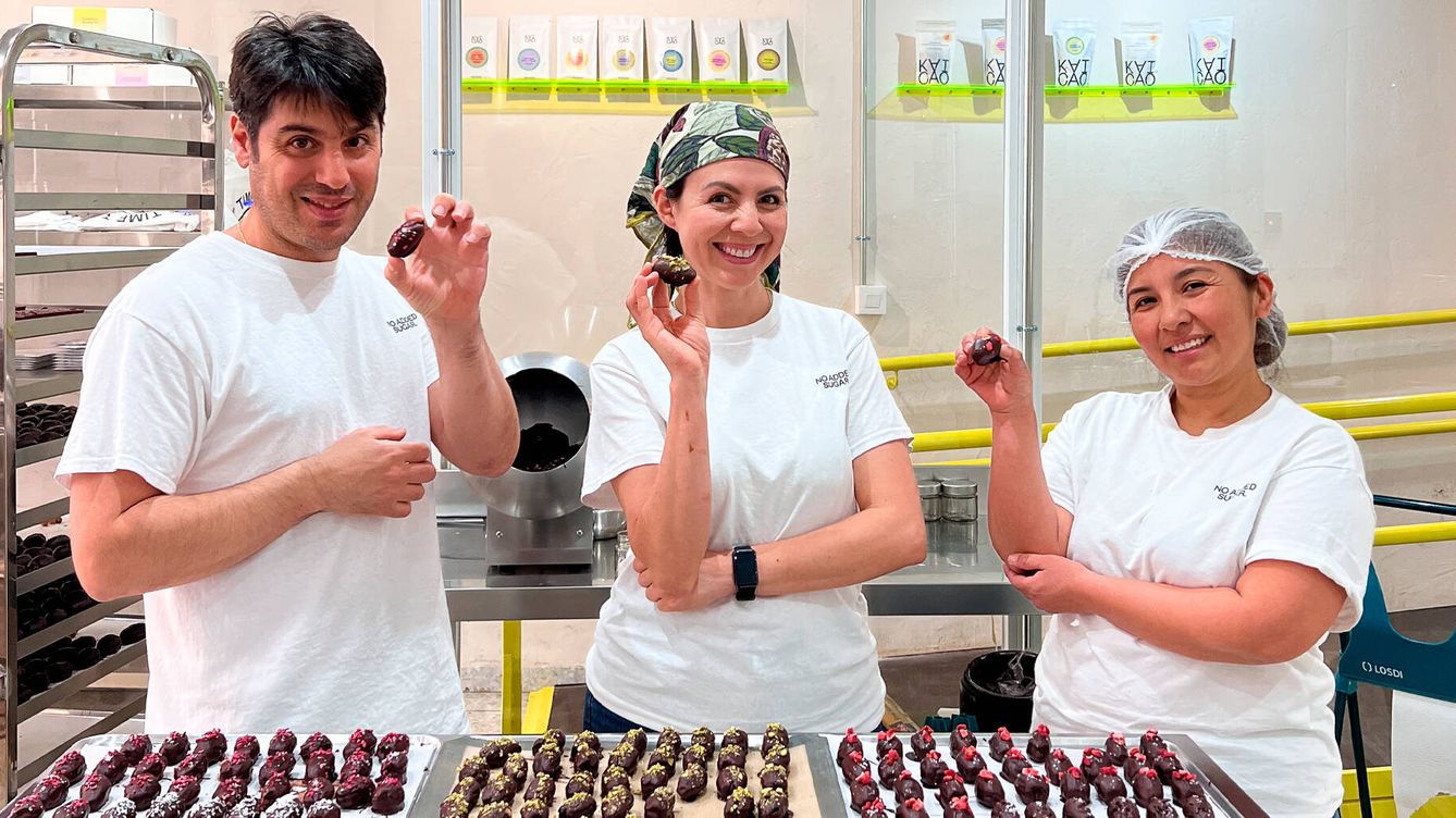 Foto:  Ido Talmor muestra una de las creaciones de su particular fábrica de chocolate junto a dos de las empleadas. (Cedida)