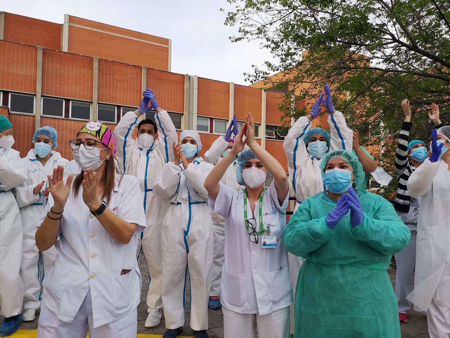 Los Sanitarios del hospital Severo Ochoa de Leganés agradecen los aplausos de los vecinos, ayer. (EFE)