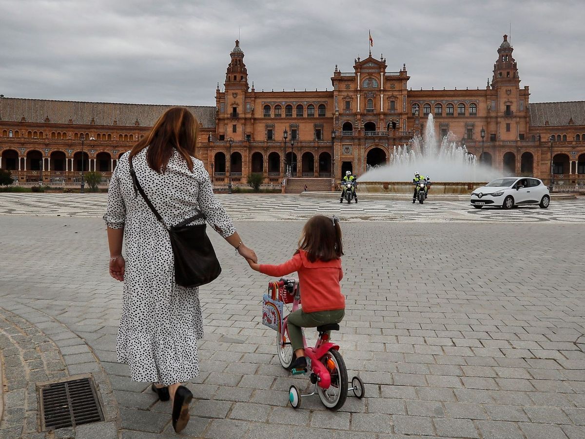 Foto: Una madre y su hija pasean por la Plaza de España de Sevilla . (EFE)