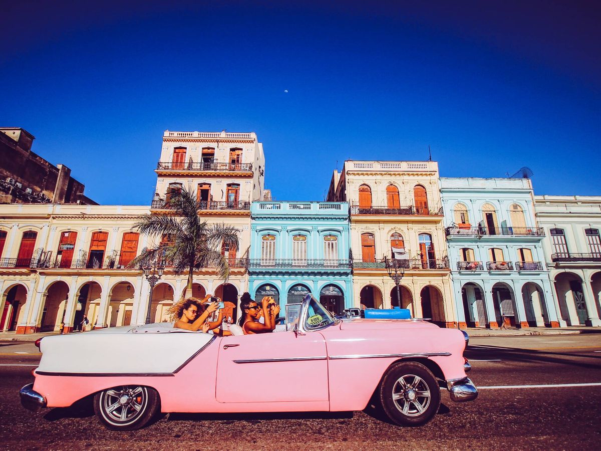 Foto: Un grupo de turistas pasea en un coche clásico en La Habana. (Unsplash/F. Wehde)