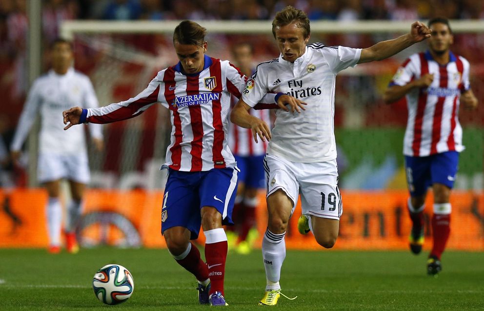 Atletico madrid's griezmann and real madrid's modric fight for the ball during their spanish super cup second leg soccer match in madrid