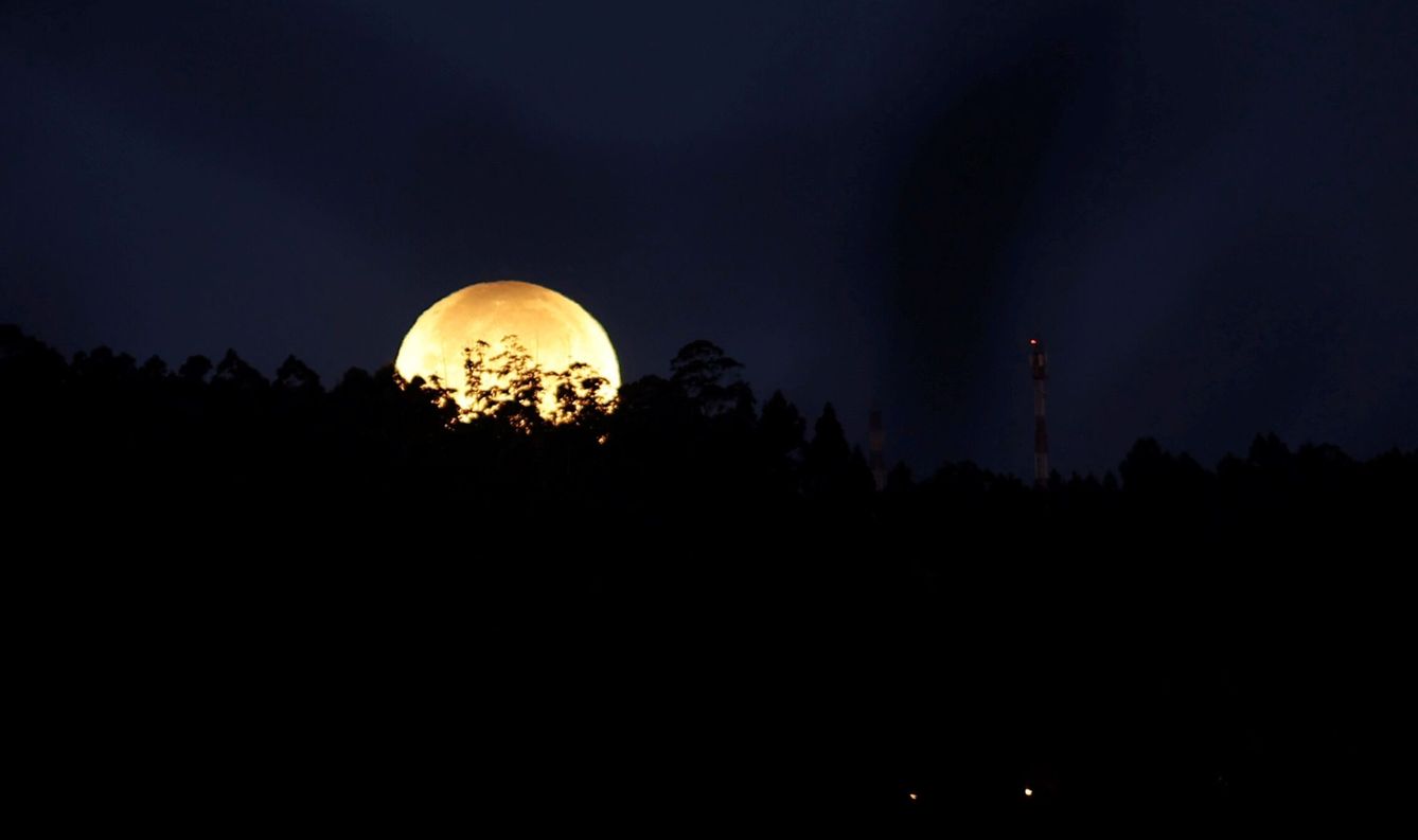 La luna se esconde tras las montañas de Ferrol, Galicia (EFE/Kiko Delgado) 