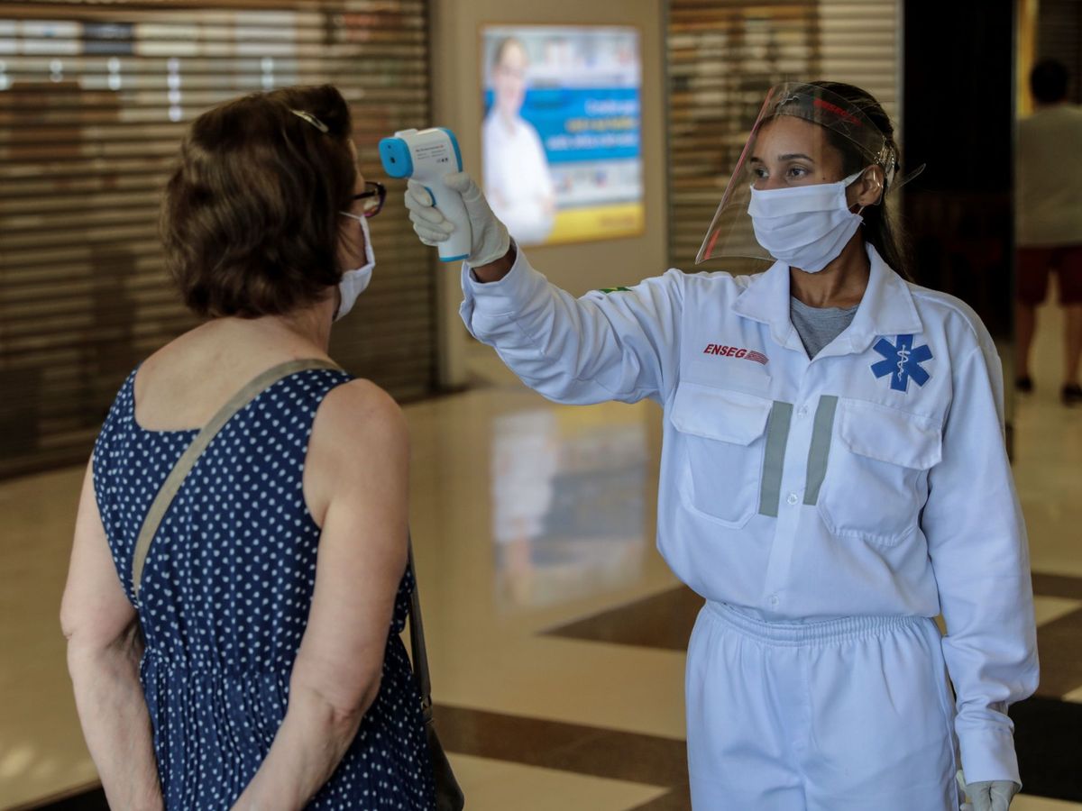 Foto: Una trabajadora sanitaria toma la temperatura. (EFE)