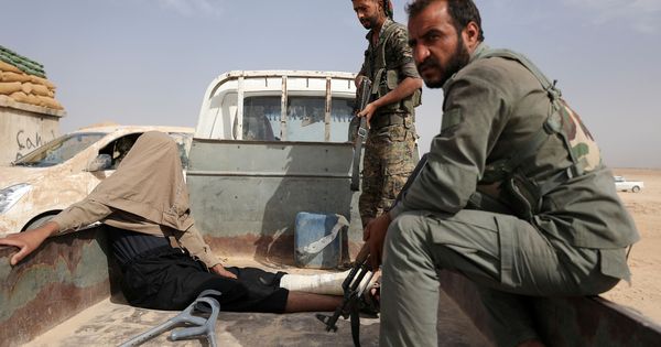 Foto: Combatientes de las SDF kurdas con un prisionero del ISIS en Deir al-Zor, Siria. (Reuters)