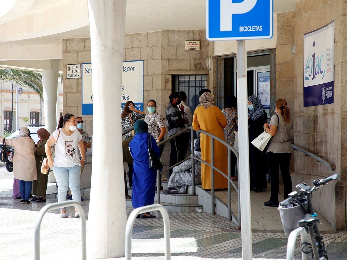 Foto: Varias personas esperan su turno para solicitar los documentos con los que pedir el Ingreso Mínimo Vital (IMV) en Melilla. (Efe)