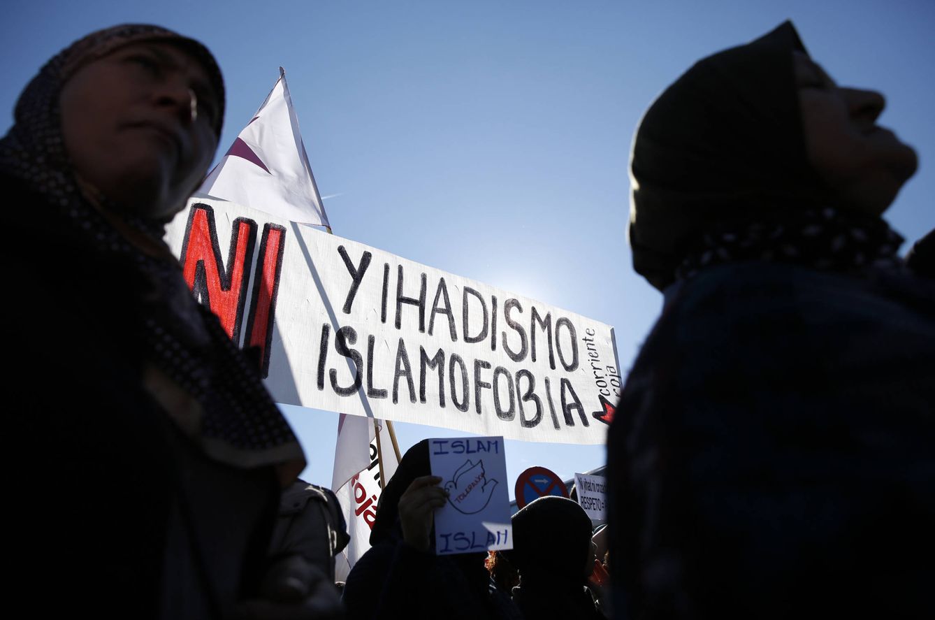 Dos mujeres, cerca de un cartel que reza 'Ni islamofobia ni yihadismo' durante una manifestación en la estación de Atocha, Madrid. (Reuters)