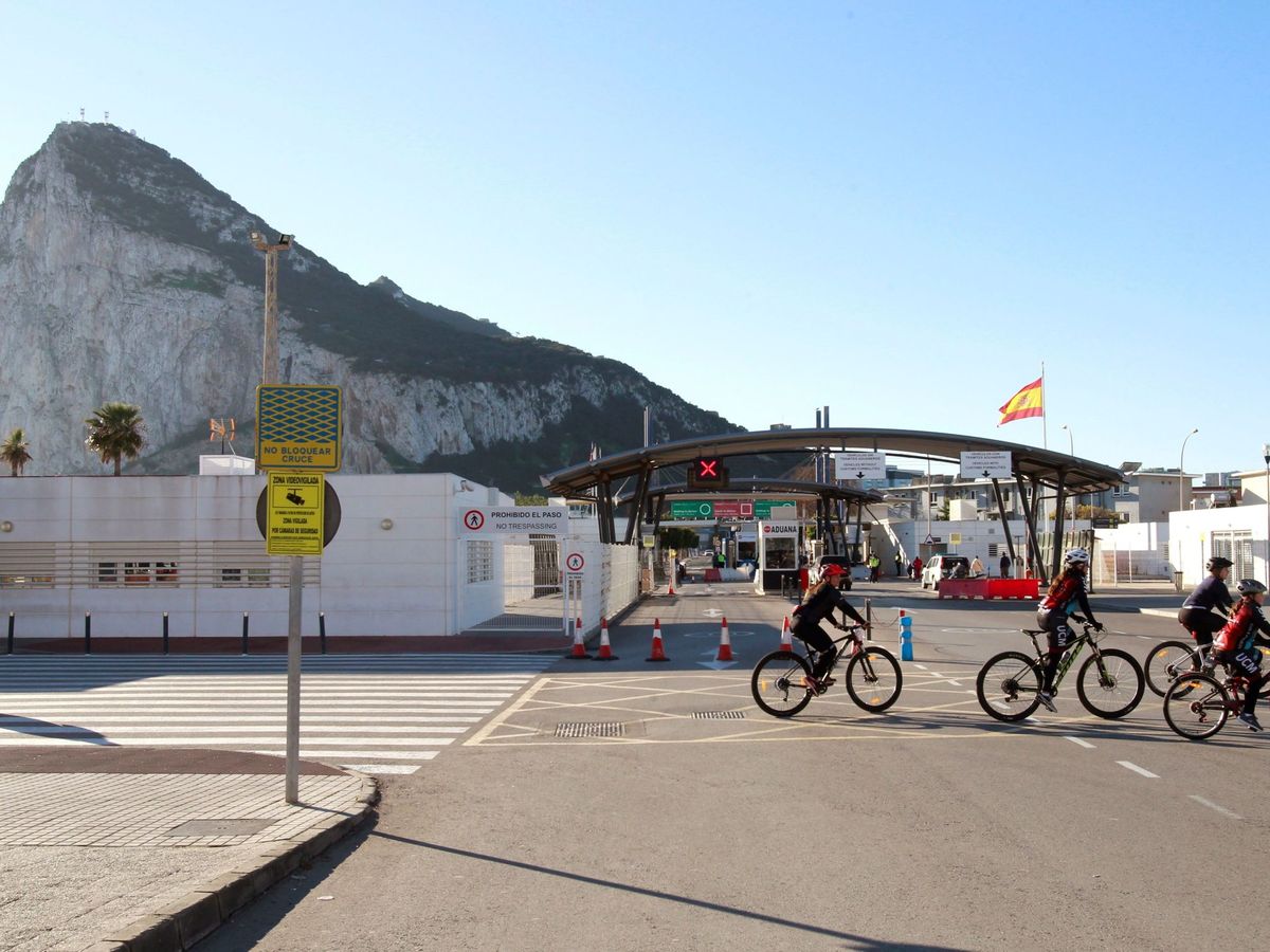 Foto: Ciclistas pasan por la frontera con Gibraltar, en la Línea de la Concepción, Cádiz. (EFE) 