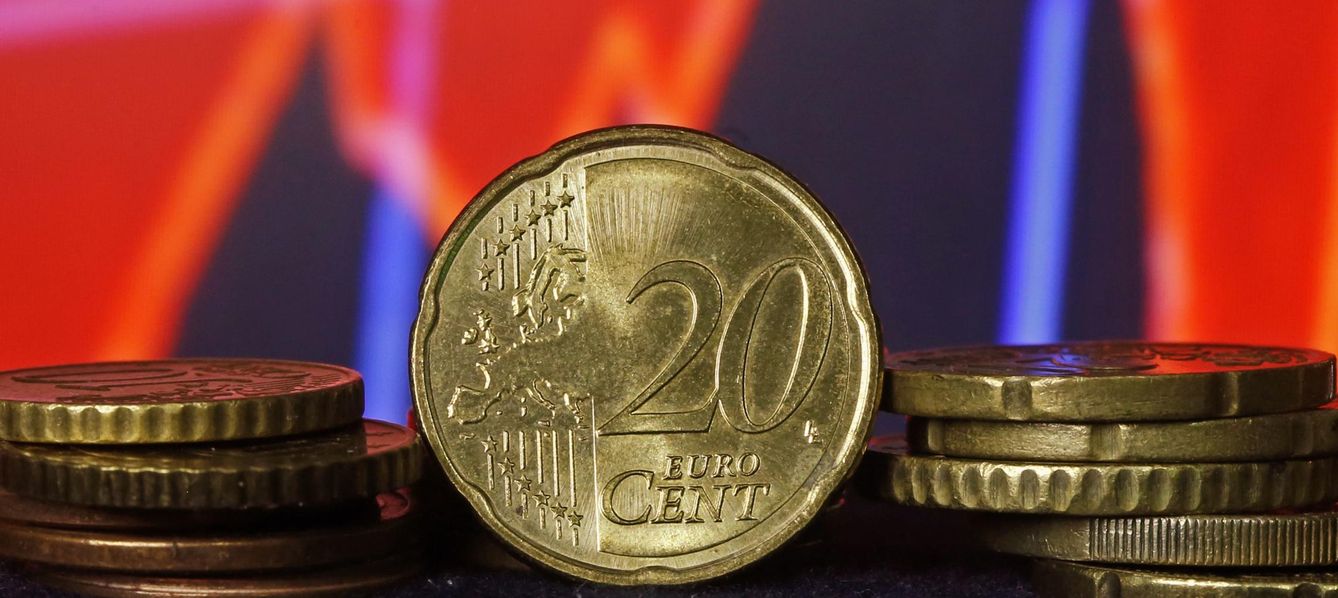 Euro coins are seen in front of a displayed stock graph in this picture illustration taken in zenica