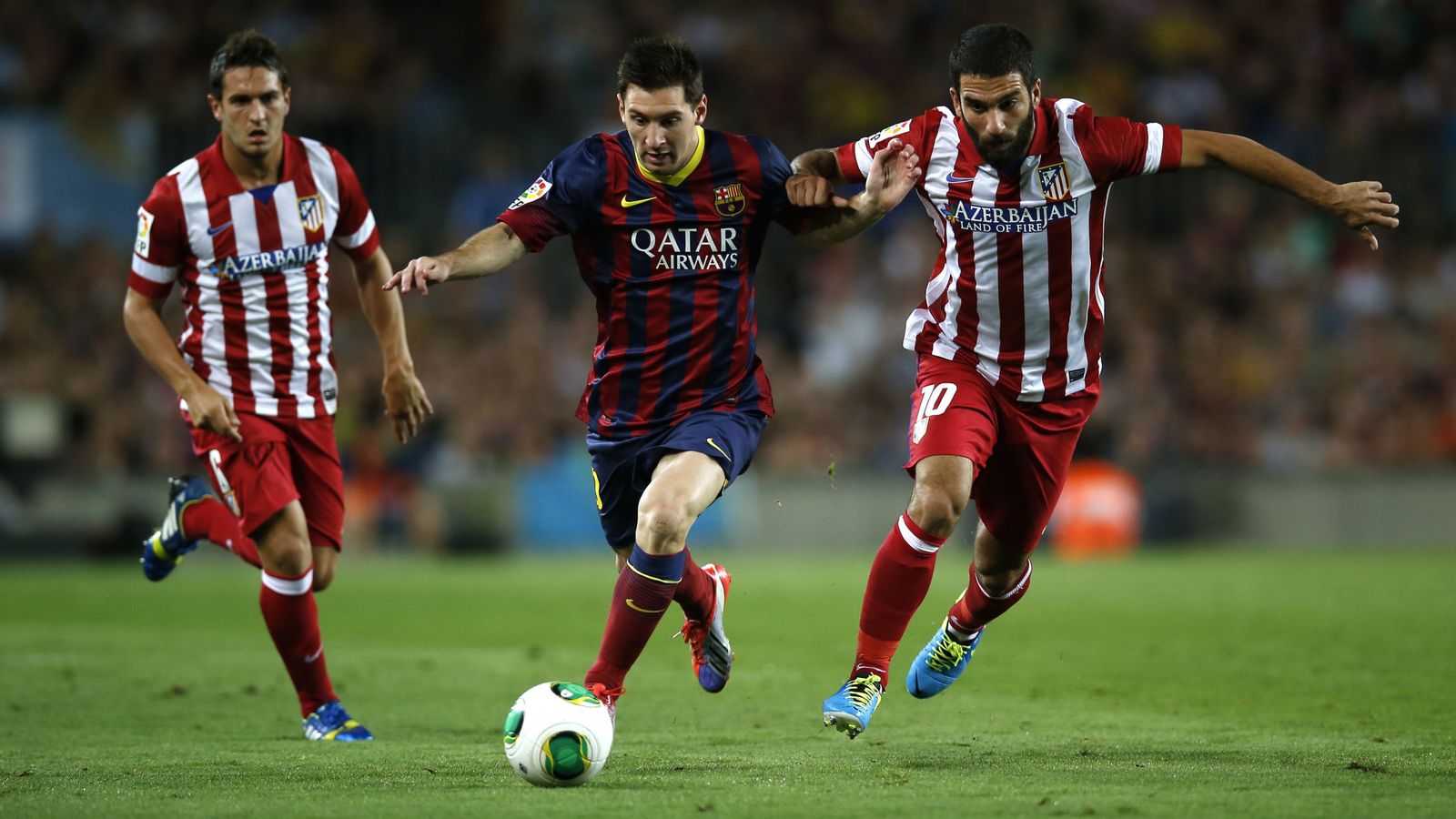 Foto: Arda Turan puja por un balón con Messi, con Koke al fondo, durante un Barcelona-Atlético disputado en el Camp Nou (Reuters)