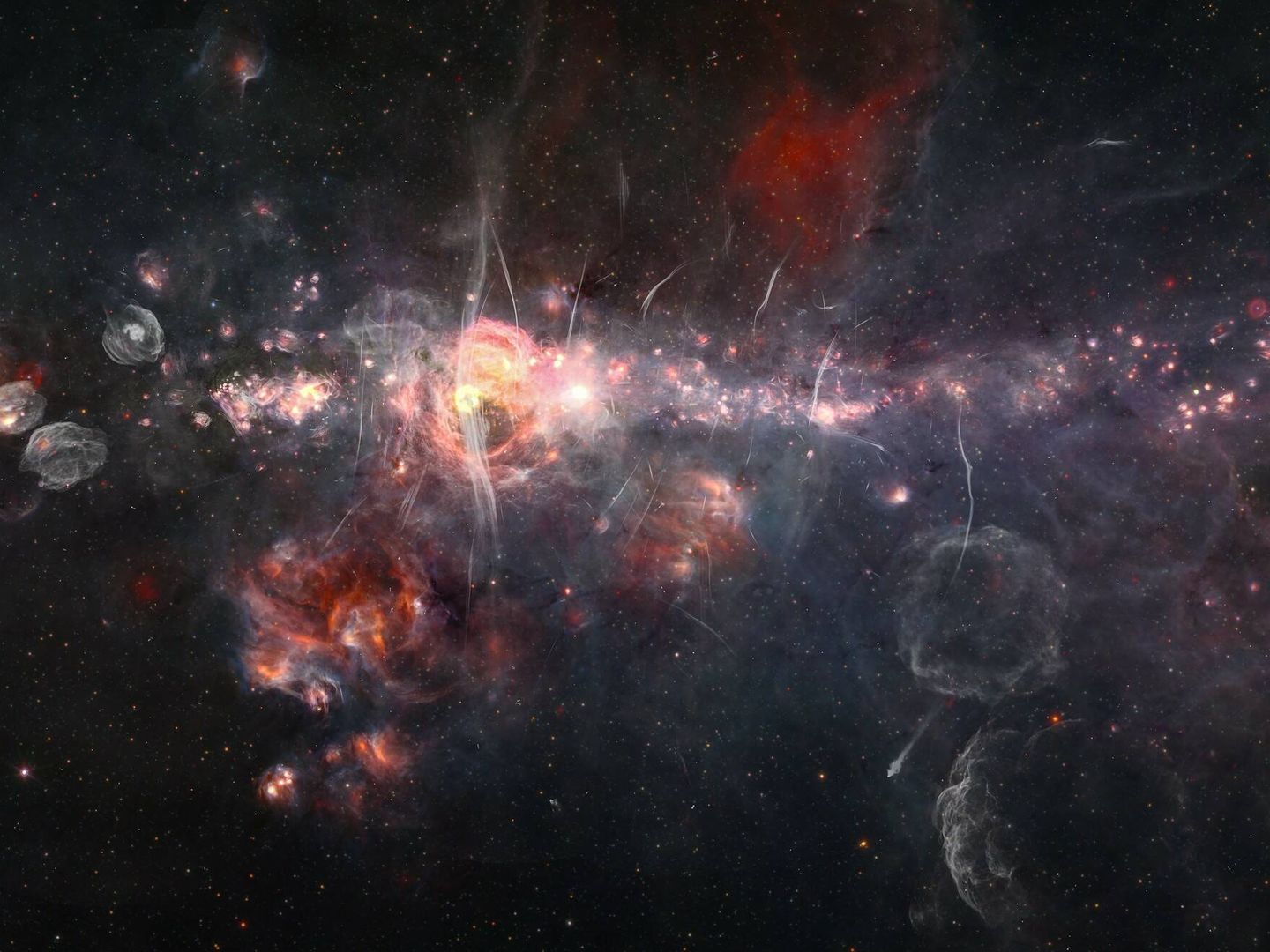 El centro de nuestra galaxia combiando datos del mosaico infrarrojo Spitzer/WISE con el estudio de ondas de radio MeerKAT. (Judy Schmidt)