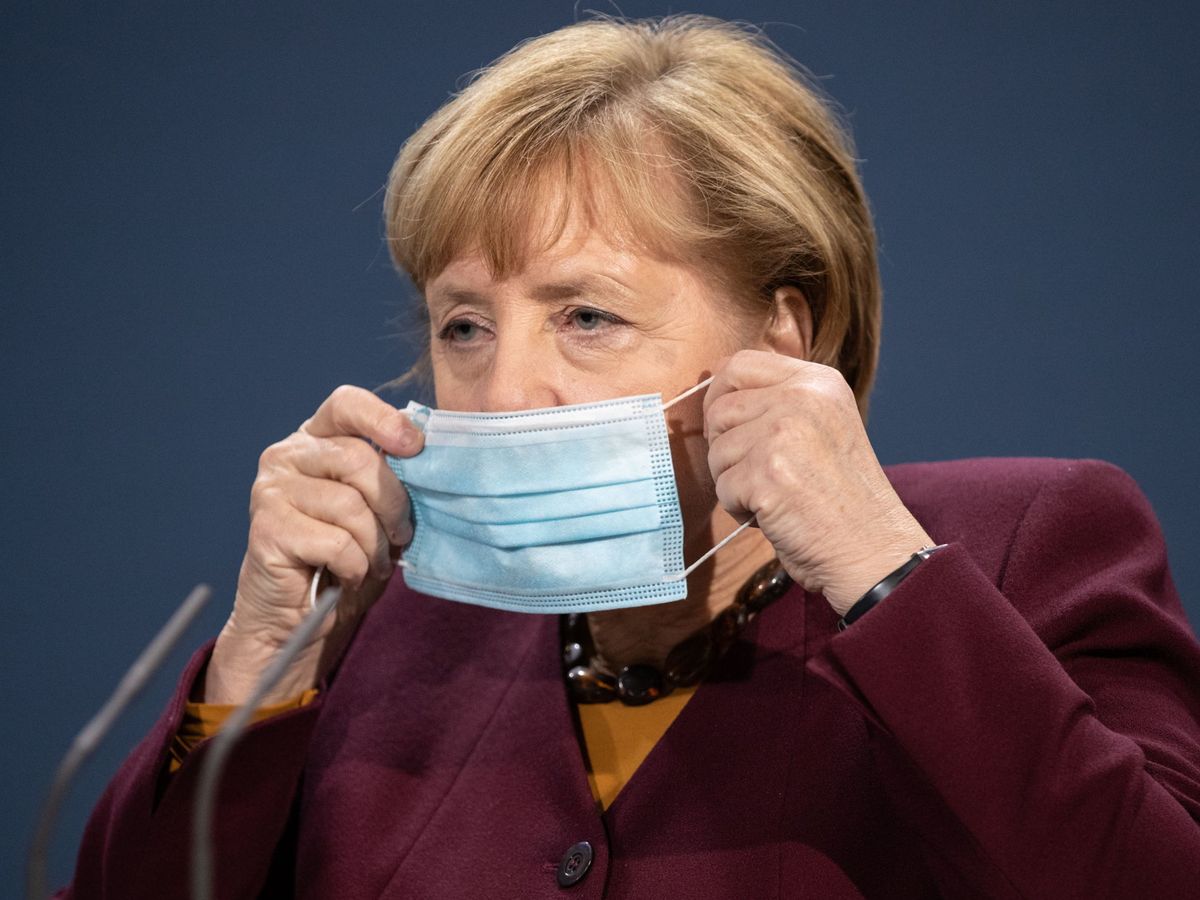 Foto: La canciller alemana Angela Merkel se coloca la mascarilla. (EFE)