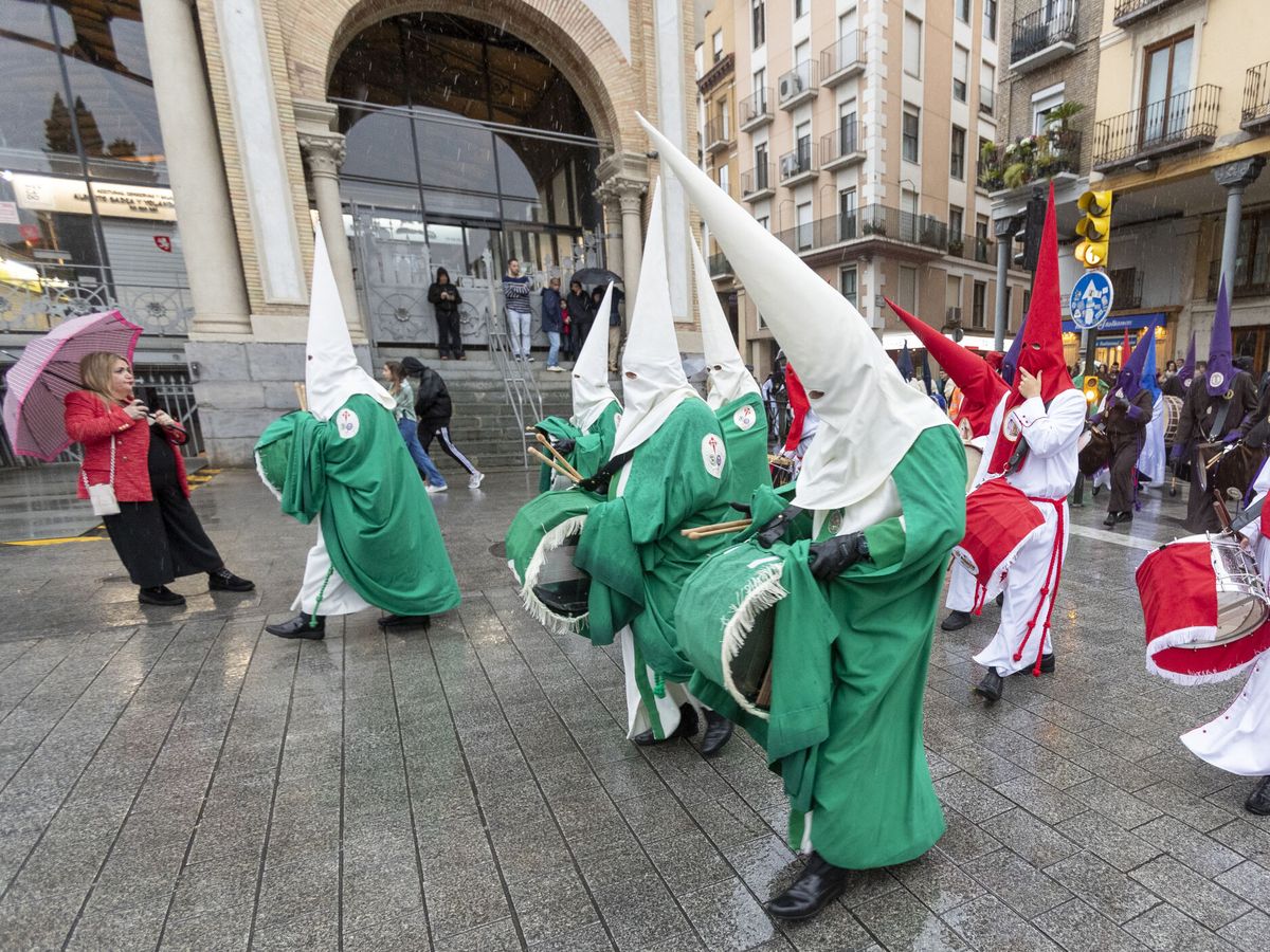 Foto: La procesión del Pregón en Zaragoza afectada por la lluvia. (EFE/JAVIER BELVER)