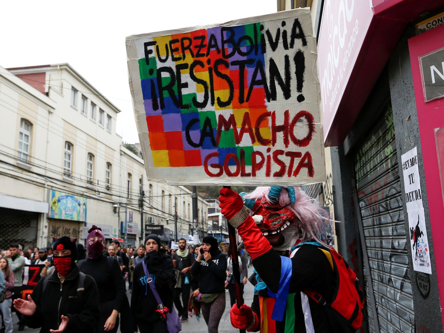 A demonstrator holds a placard that reads 'Bolivia Force, Resist, Camacho coup' during a protest against Chile's government in Valparaiso, Chile  November 12, 2019. REUTERS Rodrigo Garrido