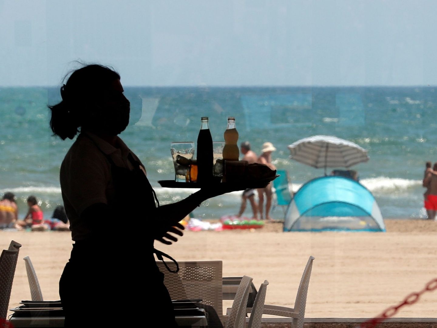 Una camarera en la playa de la Malvarrosa, en Valencia. (EFE)