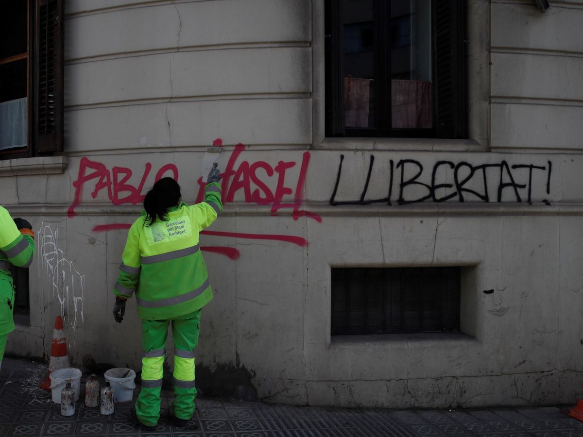 Foto:  Operarios de limpieza borran una pintada en el centro de Barcelona. (EFE) 