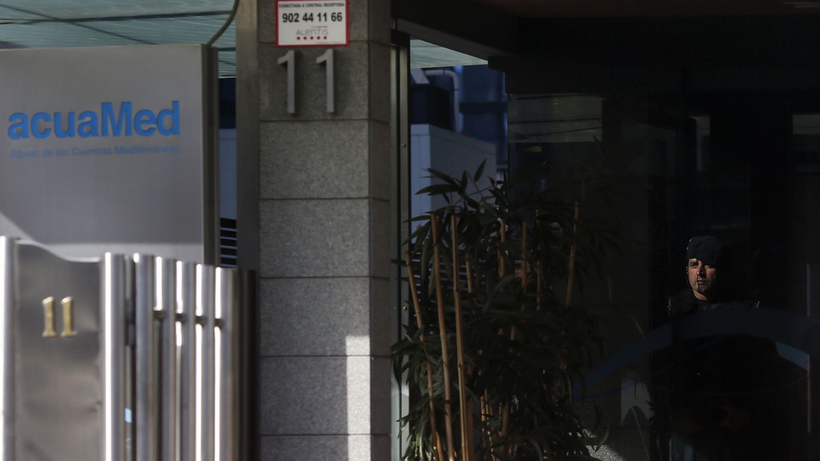 Foto: Un guardia civil, en la entrada de las oficinas de Acuamed en Madrid. (Reuters)