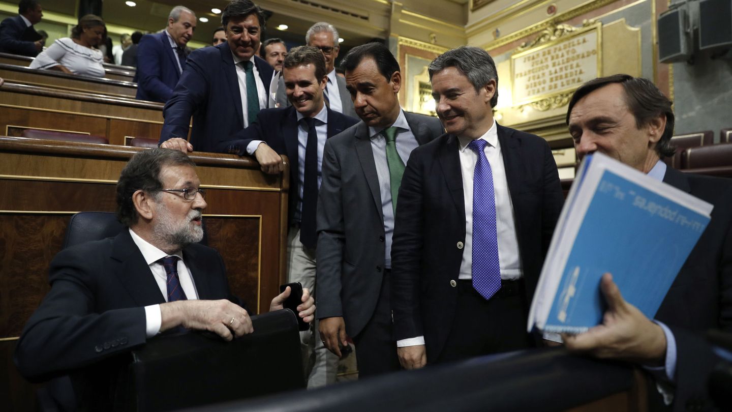 El presidente del Gobierno, Mariano Rajoy (i), conversa con diputados de su grupo. (EFE)