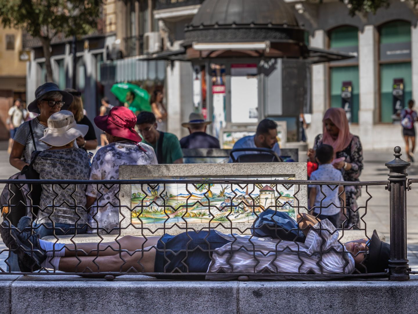 Personas descansan a la sombra en el casco histórico de Toledo. (EFE/Ángeles Visdómine)