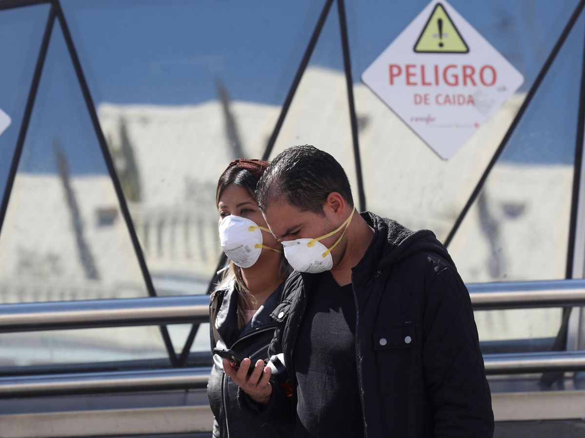 Foto: Dos personas, con mascarillas, este viernes en las calles del centro de Madrid. (EFE)