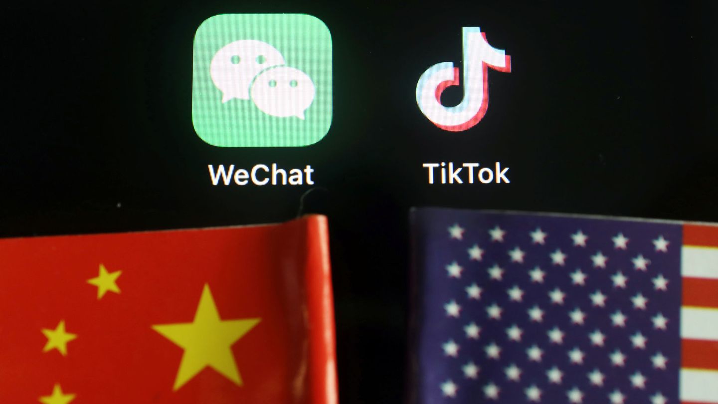 The messenger app WeChat and short-video app TikTok are seen near China and U.S. flags in this illustration picture taken August 7, 2020. REUTERS Florence Lo Illustration