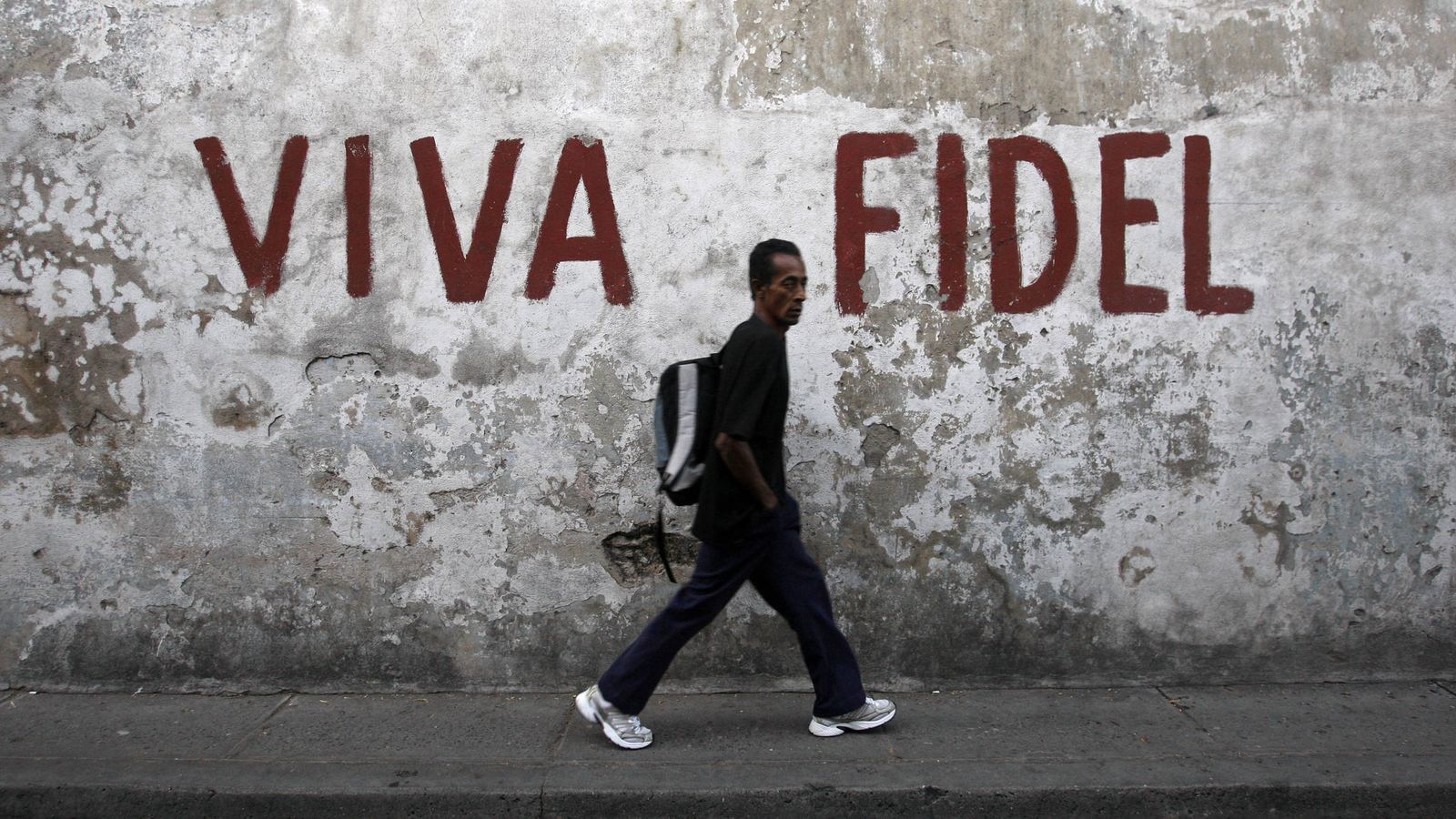 Foto: Un hombre pasa frente a un mural en apoyo de Fidel Castro en Santiago de Cuba, en diciembre de 2008 (Reuters)