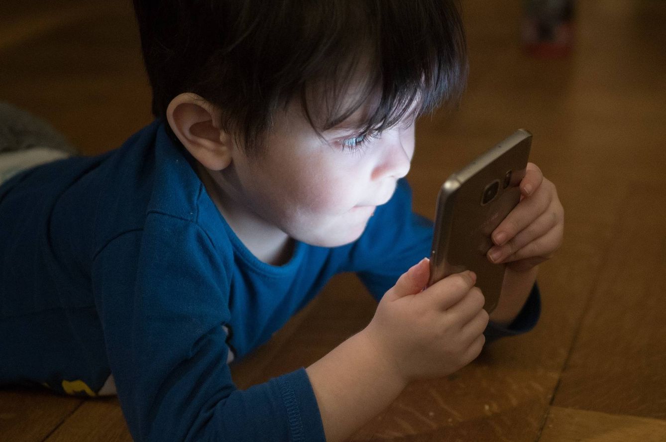 Un niño mira la pantalla de un teléfono móvil. (Pixabay)