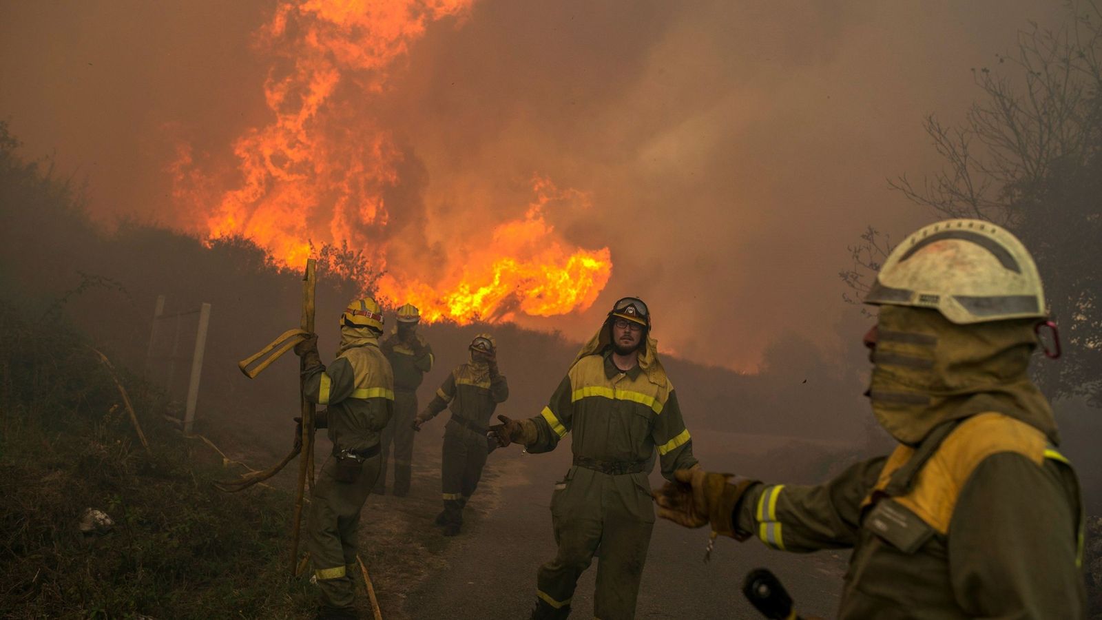 Foto: Varios brigadistas realizan labores de extinción en el incendio forestal que permanece activo desde primera hora de esta tarde en el municipio orensano de Vilamartín. (EFE)