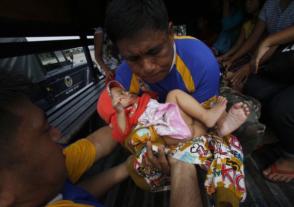 Foto: Un bebé evacuado de una zona devastada tras llegar con su familia a Manila en un avión militar (Reuters).