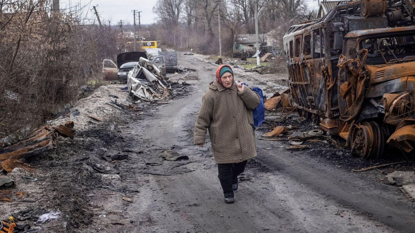 Foto: Un residente local camina por una calle vacía cerca de vehículos destruidos en la región de Donetsk, Ucrania. (Reuters/Yevhen Titov)
