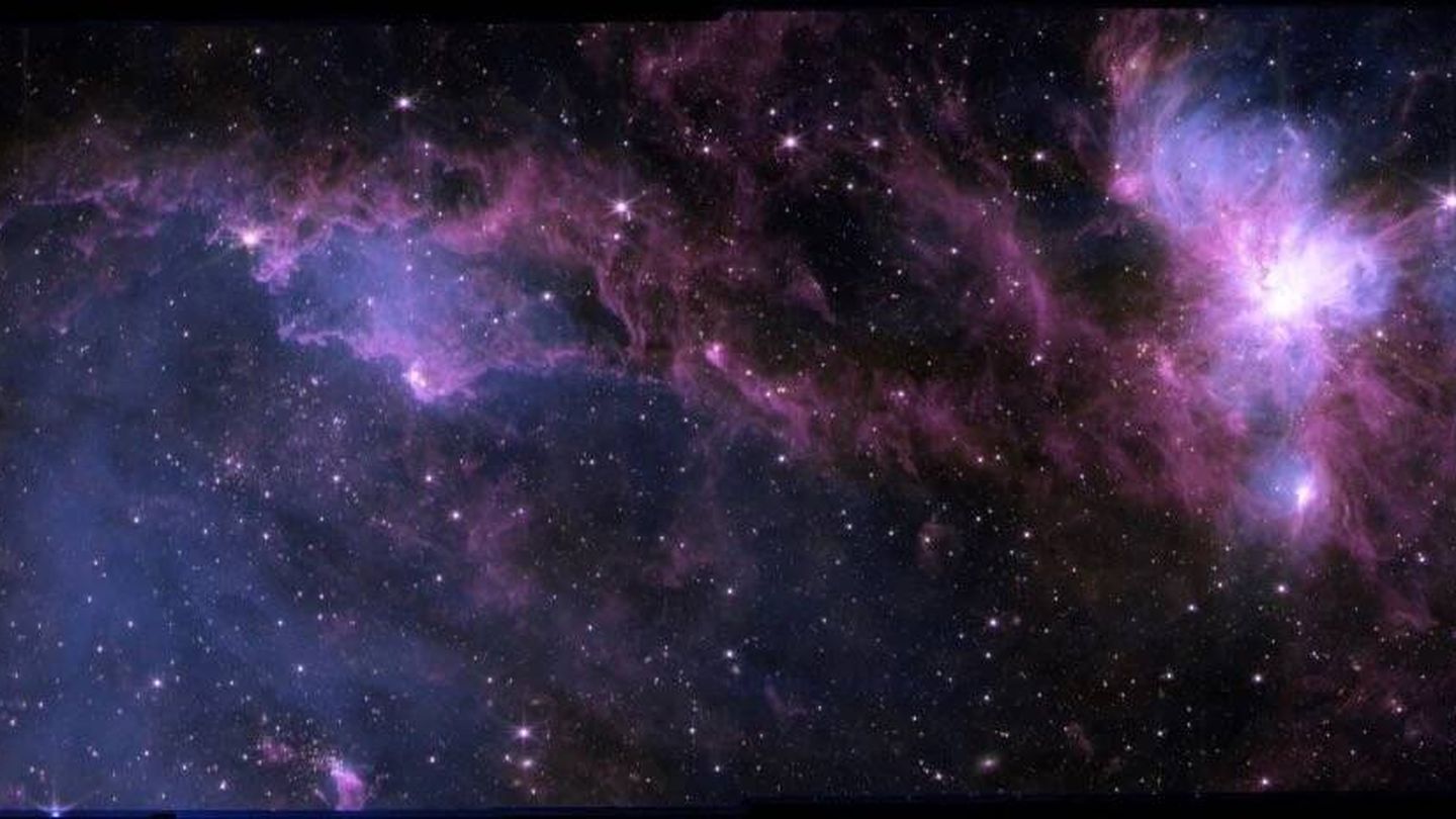 En la imagen, la luz de las estrellas se muestra en amarillo, mientras que el azul y el morado representan el polvo y el gas que alimentan la formación estelar. Dichas nubes dependen del ciclo del hidrógeno neutro para suministrar gas de hidrógeno. (NS