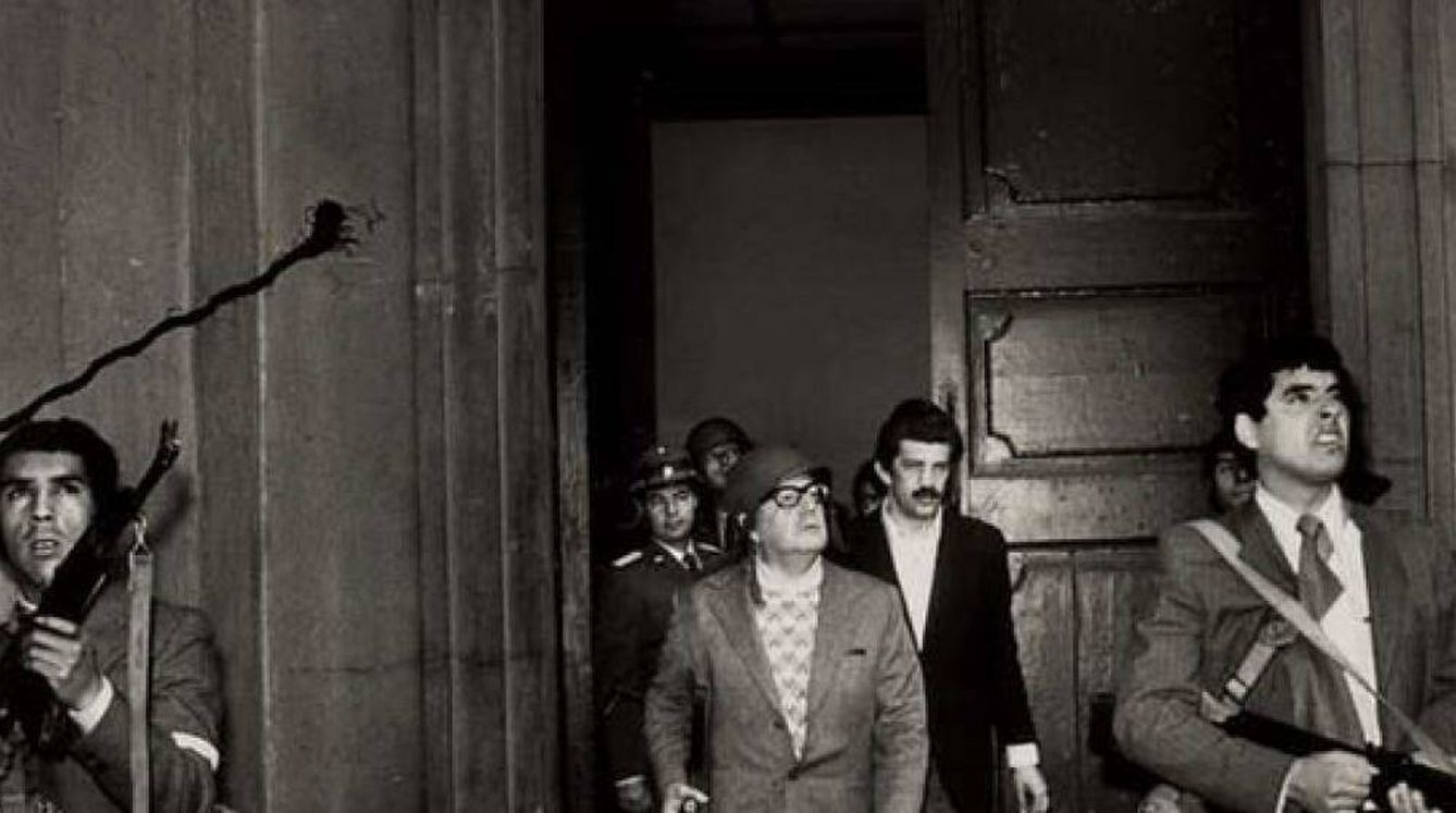 Salvador Allende, con casco y un fusil en la mano, junto a un grupo de fieles durante la resistencia en el Palacio de la Moneda.