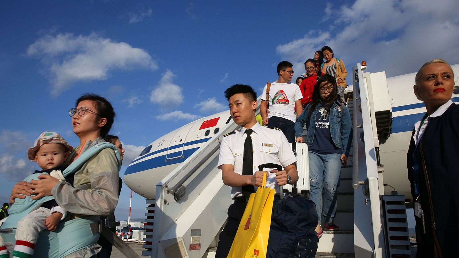 Foto: Pasajeros chinos desembarcan en el aeropuerto internacional de Atenas, en septiembre de 2017. (EFE)