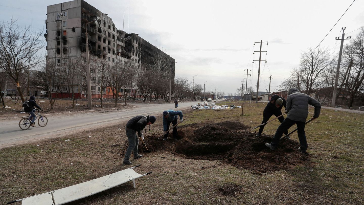 Ciudadanos cavando tumbas para los muertos en los bombardeos rusos sobre Mariúpol. (REUTERS/Alexander Ermochenko)