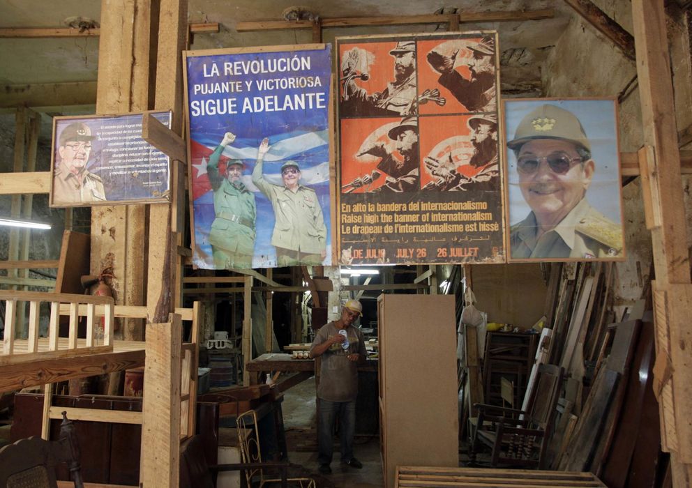 Foto: Carteles con fotografías de Fidel y Raúl Castro ayer, 17 de diciembre, en una carpintería de La Habana (Reuters)